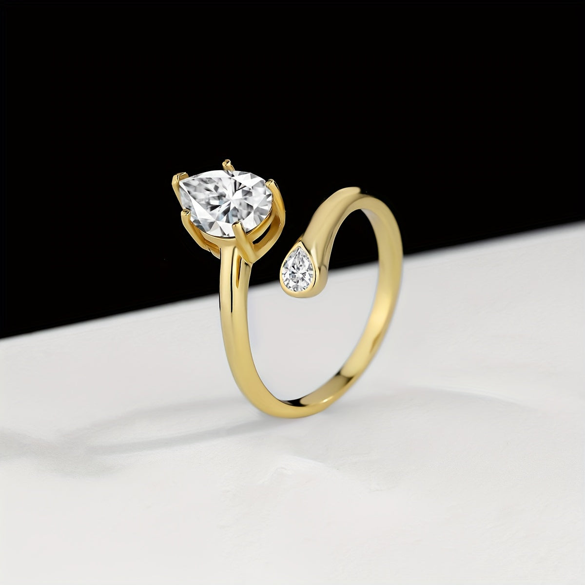 Luxurious 18K Gold Plated 925 Silver Moissanite Engagement Ring featuring a stunning 2 Carat Pear Shaped Gemstone. This Boho Royal Style ring is perfect for an April Birthstone or as a Solitaire Ring for a Wedding or Valentine's Day gift. Comes in a