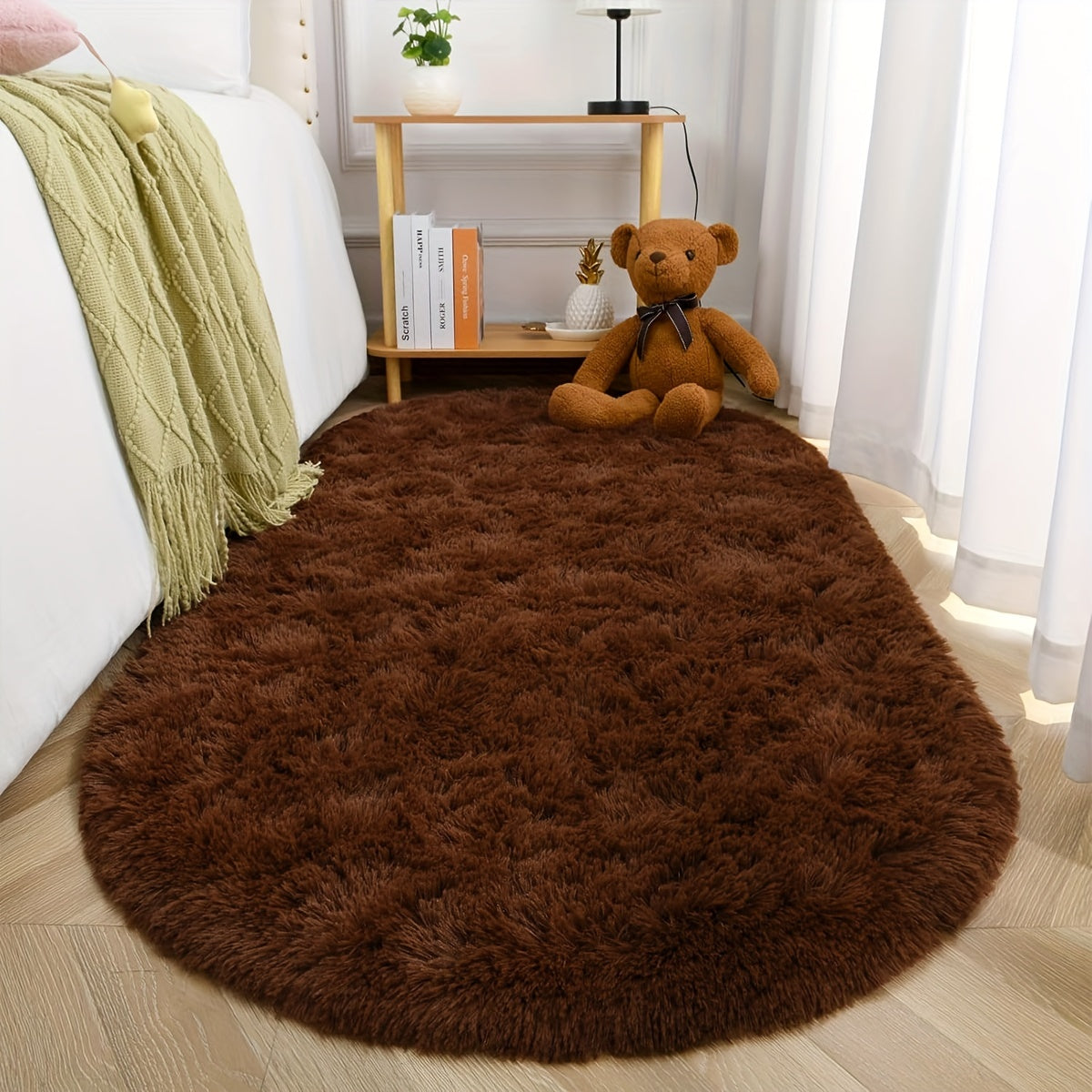 Soft and fluffy oval shaggy area rug, perfect for bedroom or living room. Made with skin-friendly thickened sponge and tufted polyester material. Durable and easy to maintain. Adds decorative touch to indoor spaces such as sofa, bedside, playroom, or