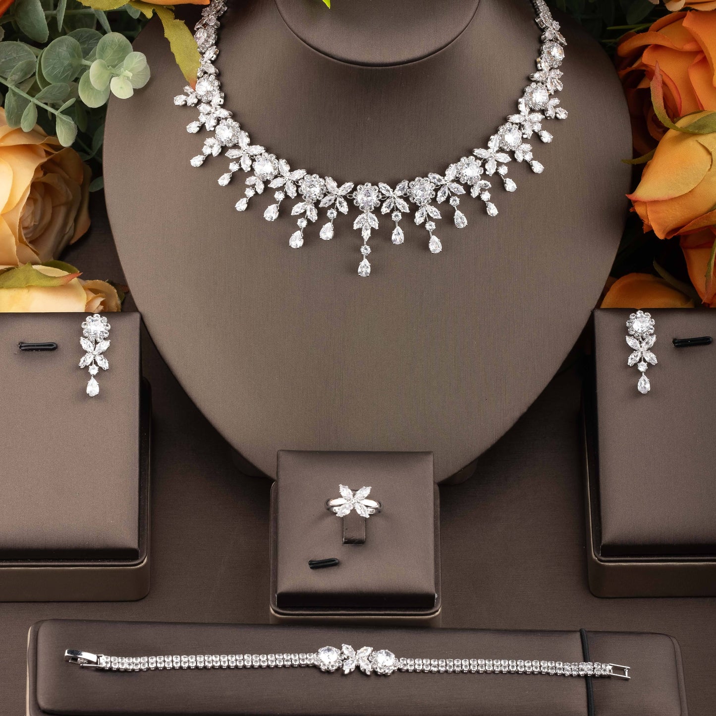 Beautiful wedding jewelry ensemble featuring intricate floral design with dazzling cubic zirconia stones, crafted in luxurious 18K gold plated copper. This set includes a necklace, earrings, bracelet, and ring, perfect for both bridal wear and special