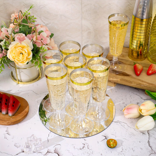 A pack of 25 elegant plastic champagne flutes with golden rims, each holding 5.5 oz. These acrylic mimosa glasses are recyclable and perfect for parties. They are machine washable and can be used for various occasions such as weddings, Christmas