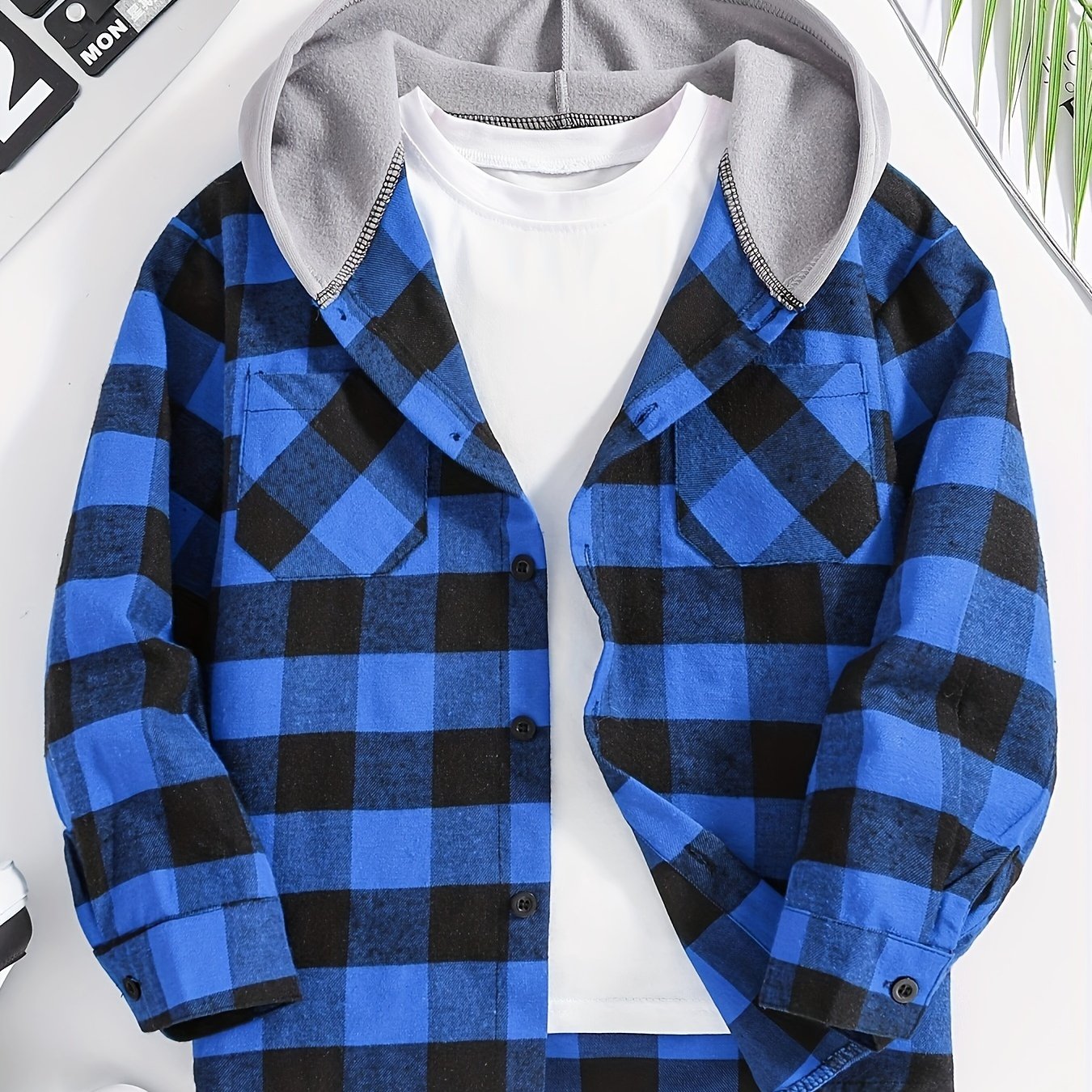 Boys' plaid hooded shirt in blue and black with flap pockets, made of cozy polyester for fall/winter casual wear.