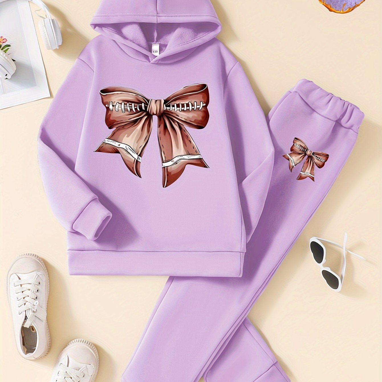 Cozy and stylish girls' 2-piece set featuring fleece-lined hoodie with bow design and matching joggers, ideal for fall/winter and outdoor activities.