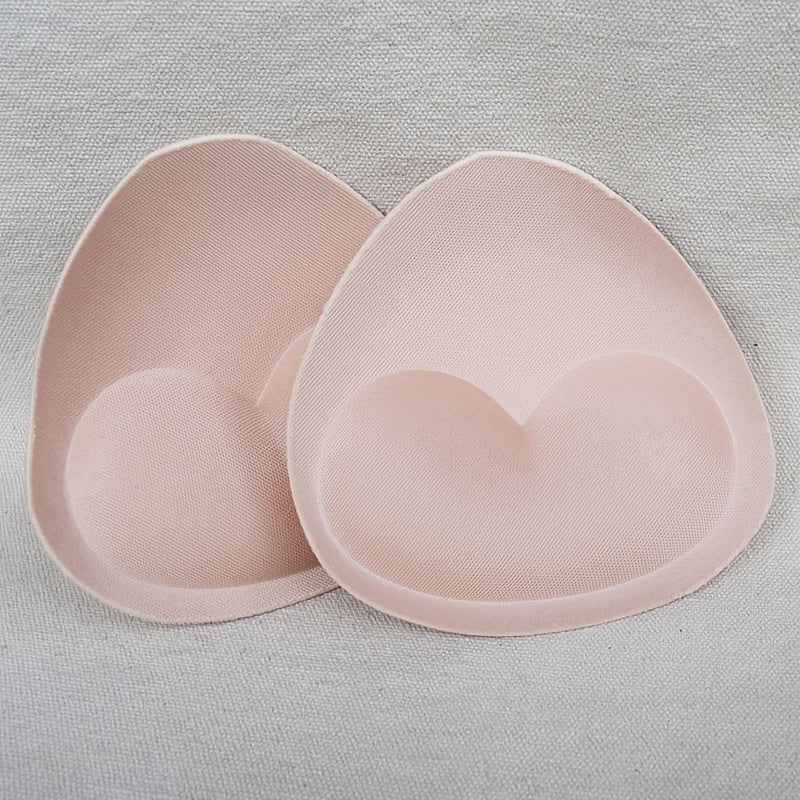 2 pairs of heart-shaped sponge bra inserts, washable and removable cup enhancers for bikinis, tops, and bras. Made from soft and breathable PU material for comfortable fit.