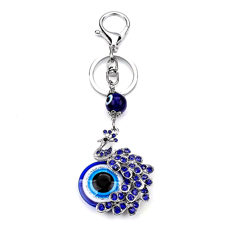 Blue Evil Eye Keychain with Rhinestone Inlaid Peacock Design, made from Alloy, Perfect for Women's Daily Use as a Trendy Hanging Pendant or Bag Charm.