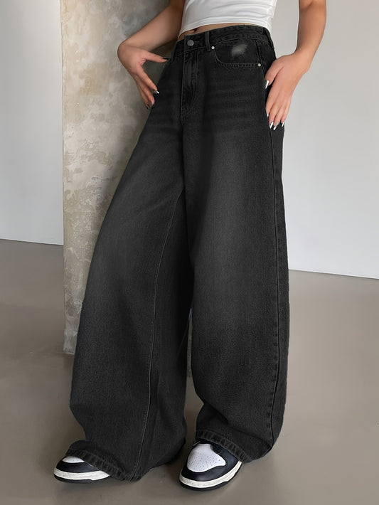 Vintage washed blue denim wide leg jeans for women, with oversized floor-length cut, distressed detail, loose fit, and fashionable streetwear style.