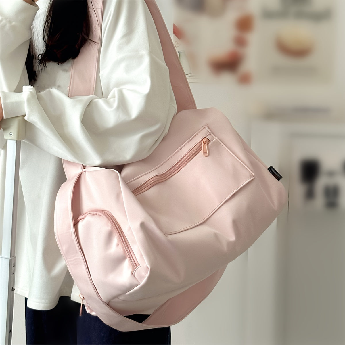 Pink duffel bag with headphone jack for gym, travel, and short trips; lightweight, stylish, and portable.