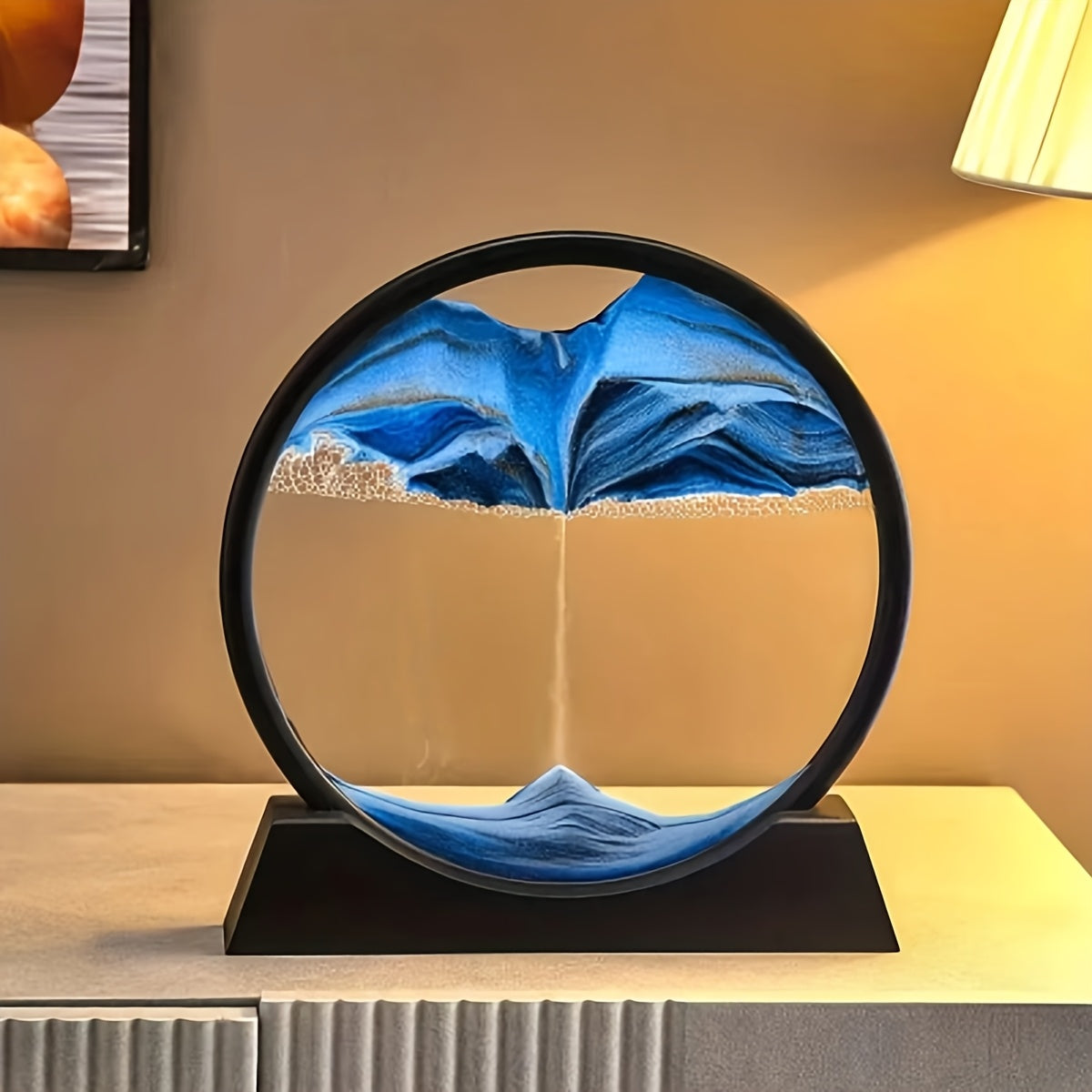 Large round glass frame with flowing sand creates a 3D deep sea scene as a relaxing home and office decoration.