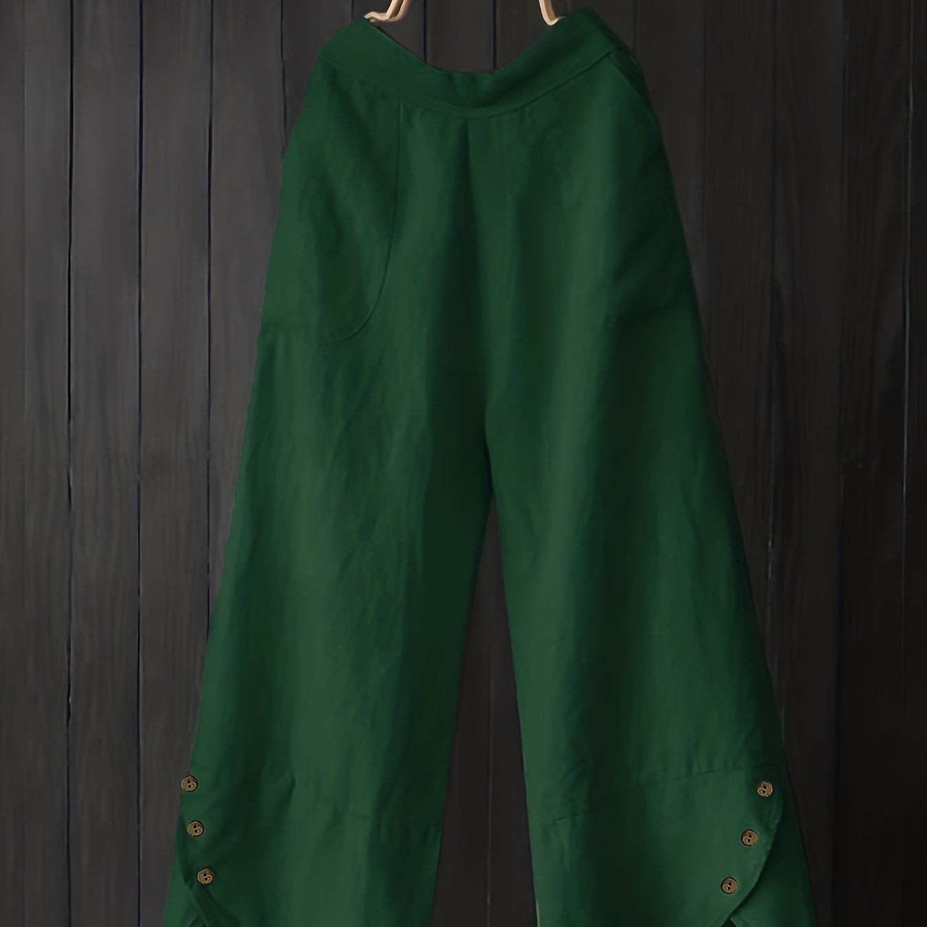 Green high-waist wide leg pants with unique button details, loose fit, pleated design, ideal for fall outings.