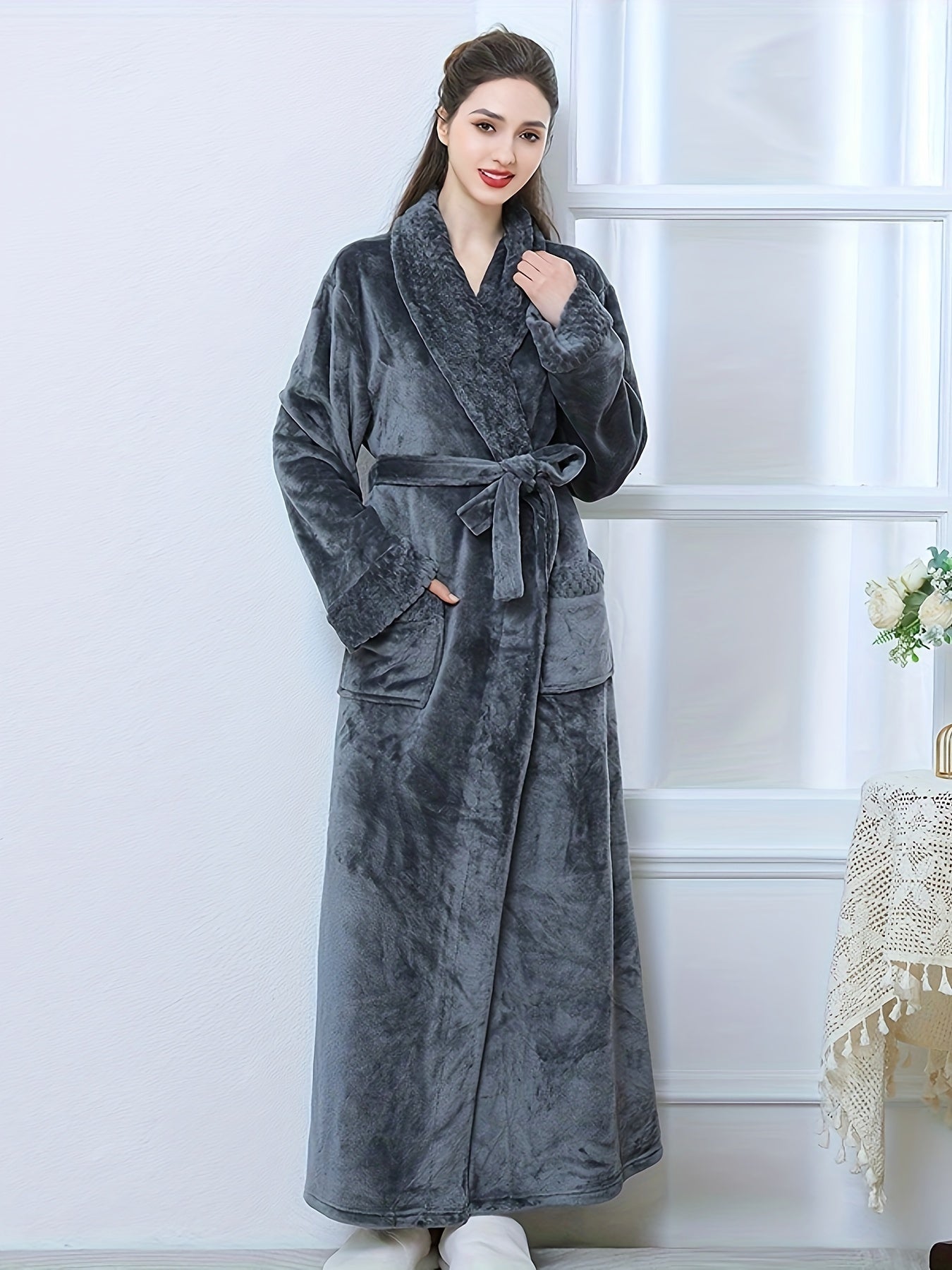 Plush pink flannel bathrobe for women with long sleeves, V-neck, and pockets. Machine washable for winter warmth.