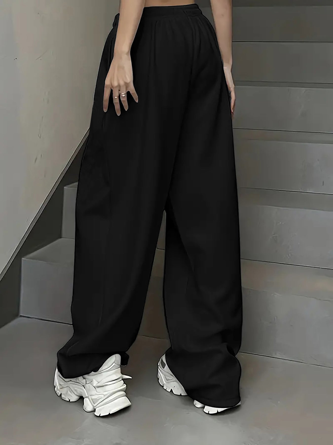 Women's casual joggers with letter print, drawstring elastic waist, pockets, and hip-hop streetwear style.