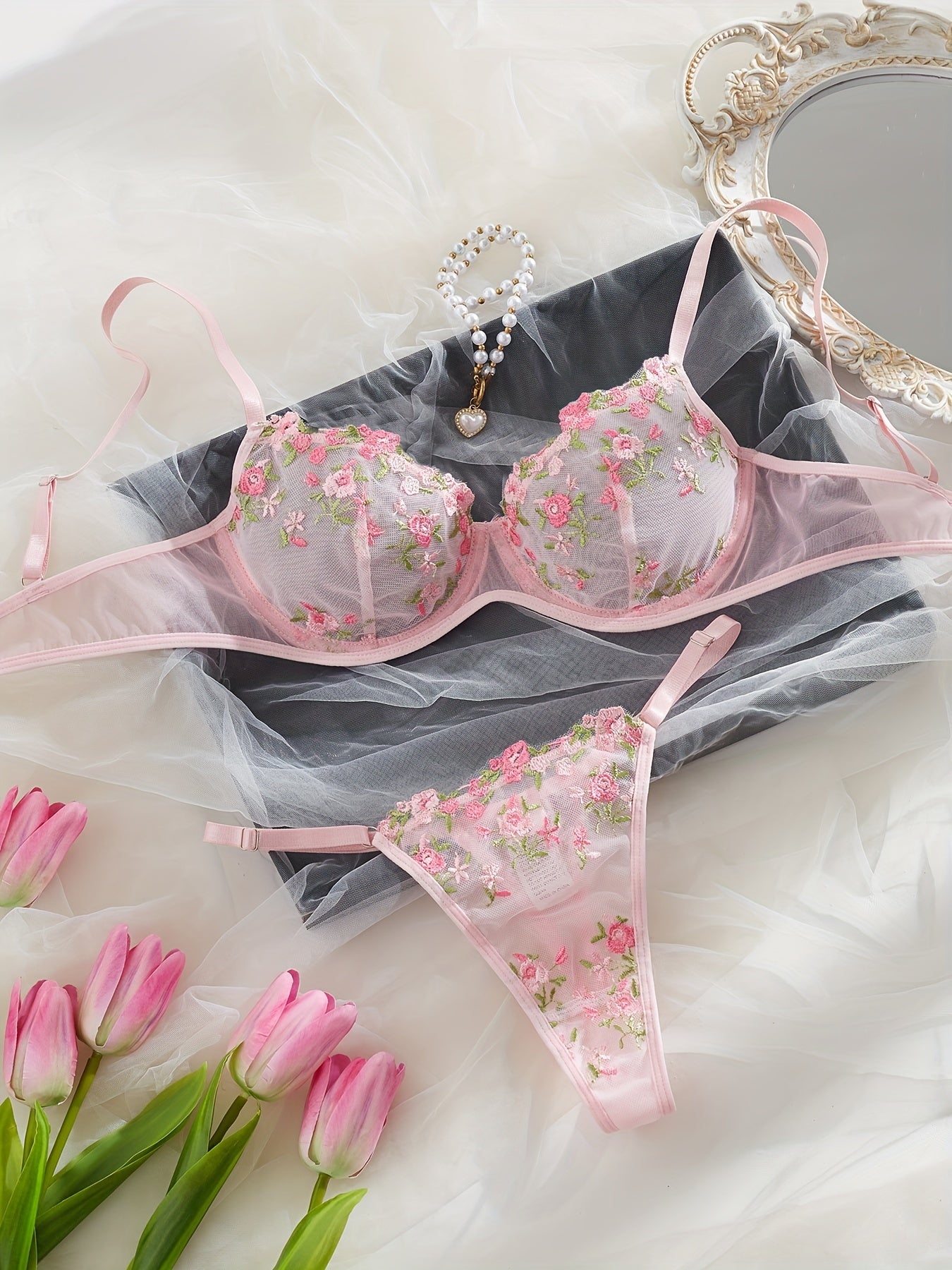 Chic French-inspired lingerie set in pink with floral embroidery and butterfly lace, featuring a sheer mesh bra and thong combo, medium support, hand wash only.