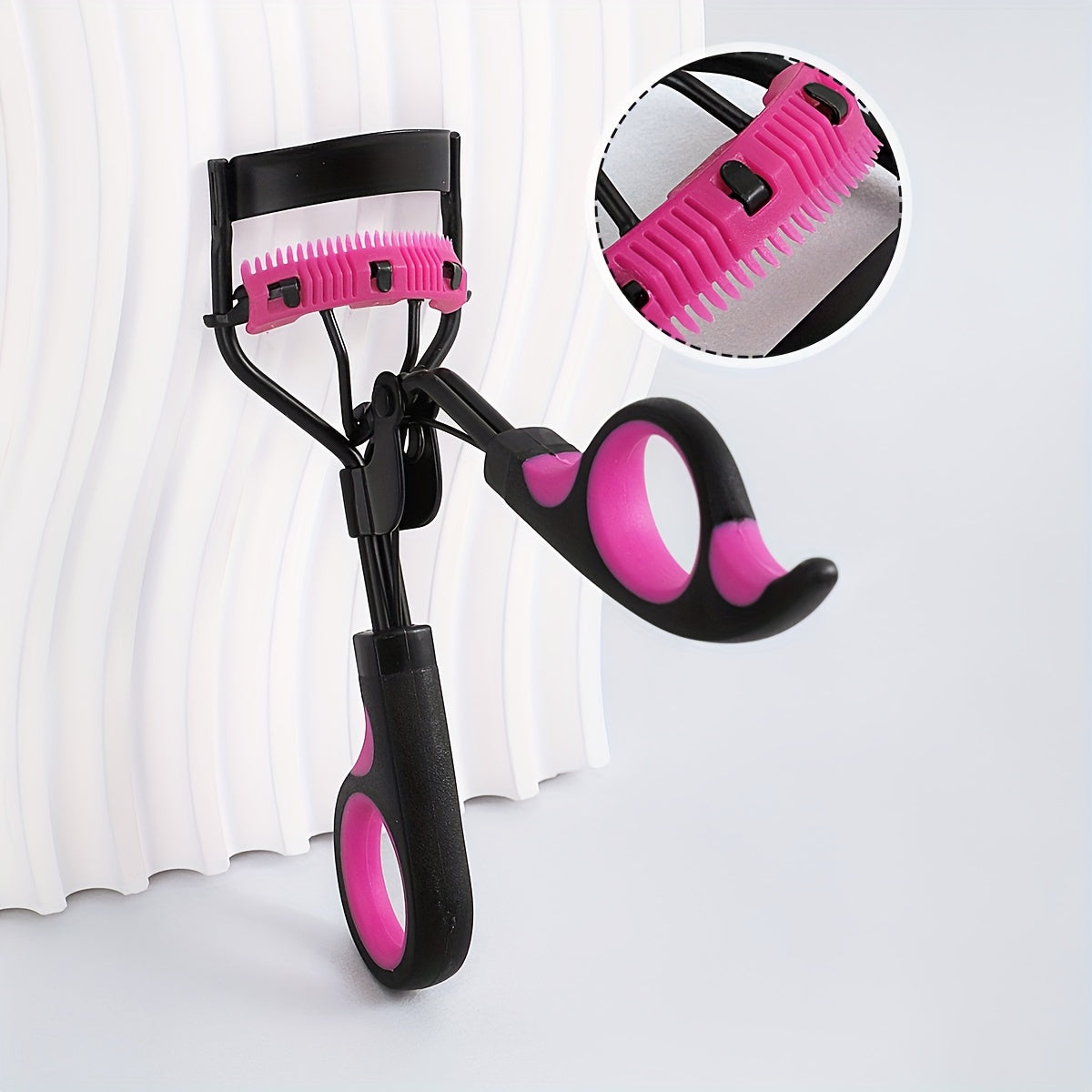 Compact eyelash curler with stainless steel curler and comb for lasting curl, ideal for daily use to enhance lashes.