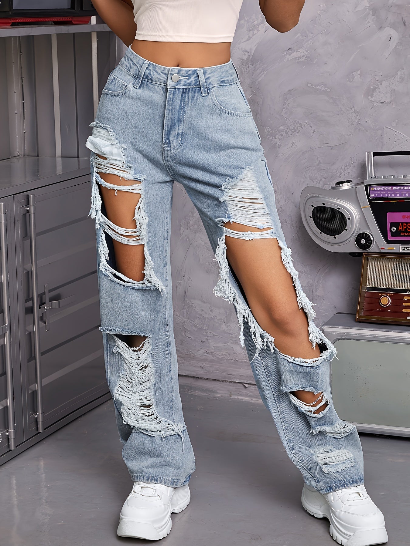 Vintage high-waisted distressed jeans for women in light blue wash, featuring a casual loose fit with pockets.