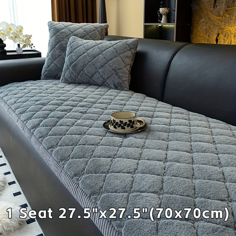 Modern quilted sofa cover, pet-friendly, machine washable, non-slip, thick polyester protector for various furniture sizes and styles in home or office décor.