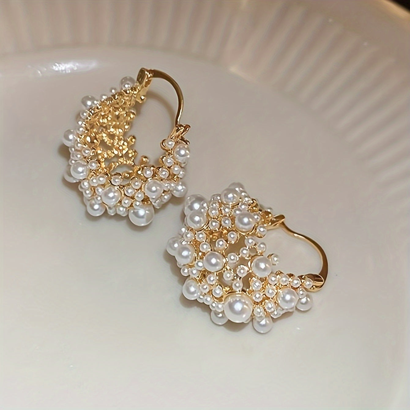 Elegant French-style U-shaped hoop earrings featuring faux pearls and beads, with a delicate hollow-out design ideal for women. A must-have accessory for vacations and parties.