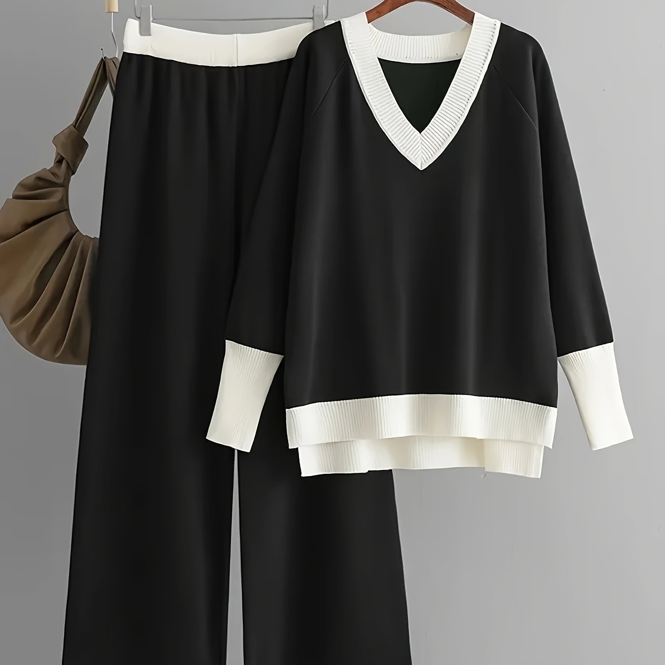 Viscose knit two-piece outfit for women, including a color block V-neck sweater and matching trousers in a solid color.