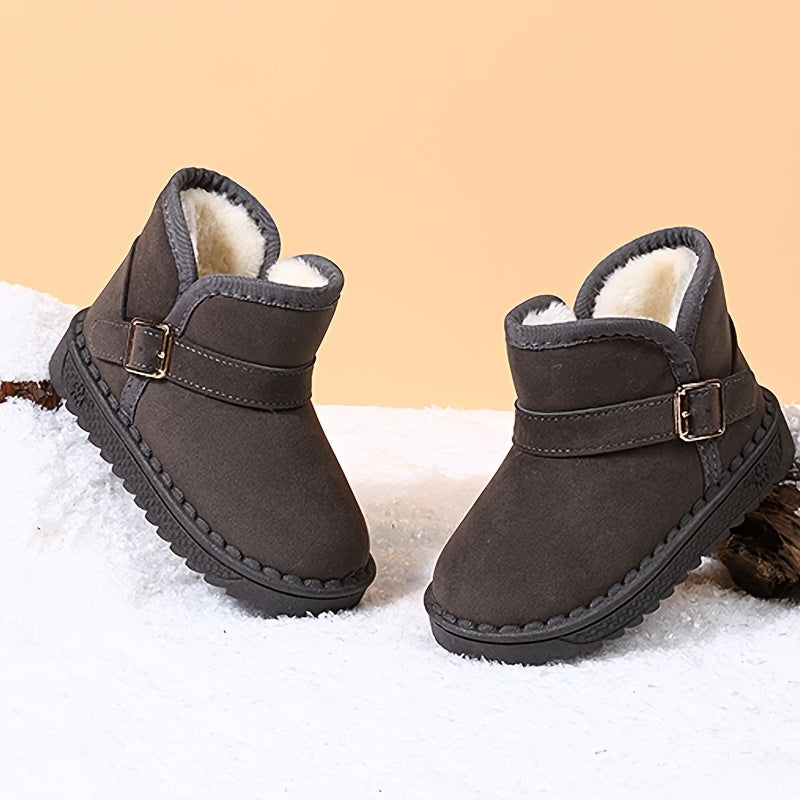 Children's winter boots with cozy fleece lining, warm and breathable, slip-on style with metal buckle straps, available in black and brown for boys and girls.