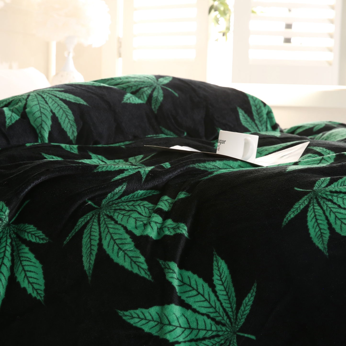 Country-rustic style flannel blanket featuring a marijuana leaf print. This soft and warm knitted throw is perfect for couches, sofas, offices, beds, camping, and travel. Made of 100% polyester, it is machine washable and suitable for all seasons.