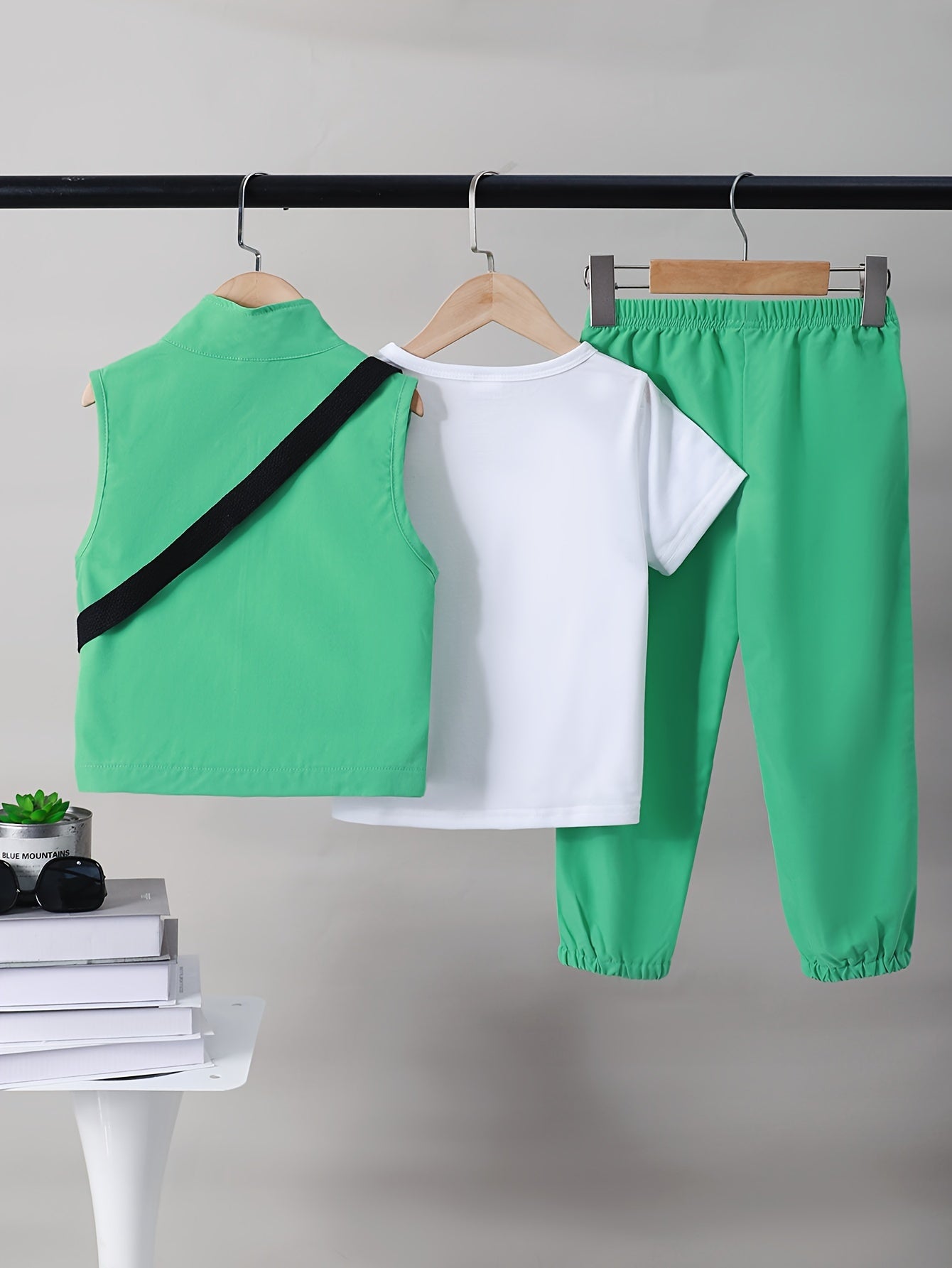 Boys 4-piece spring outfit: Short sleeve t-shirt, sleeveless vest, cargo pants, and crossbody bag. Cool, lightweight, and comfy for outdoor wear.