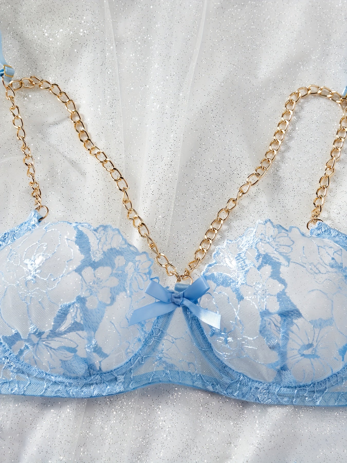 Floral embroidery semi-sheer lingerie set with chain-linked underwire bra, thong, and garter belt. Sexy women's underwear.