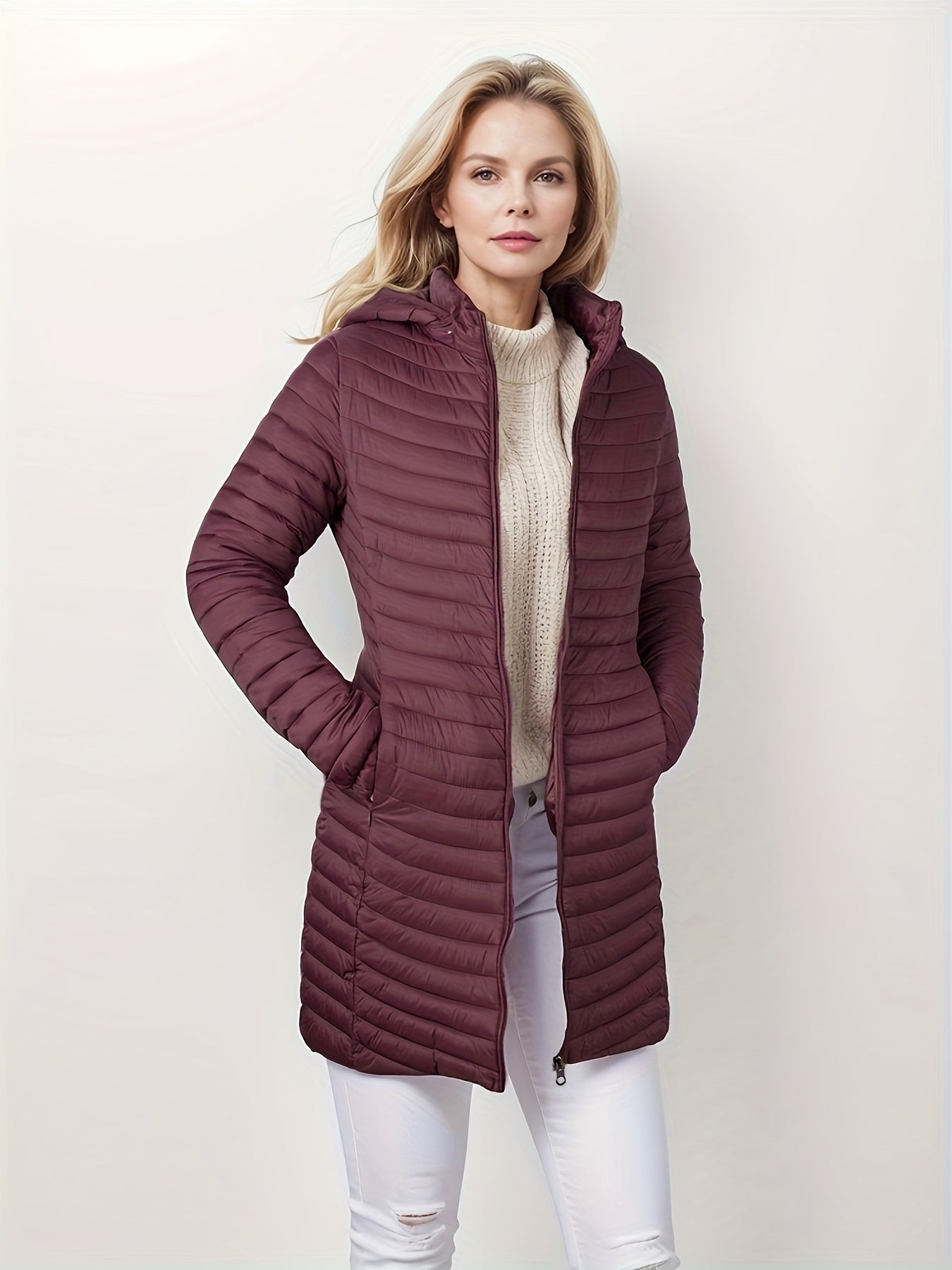 Women's lightweight puffer coat with detachable hood, perfect for winter comfort.