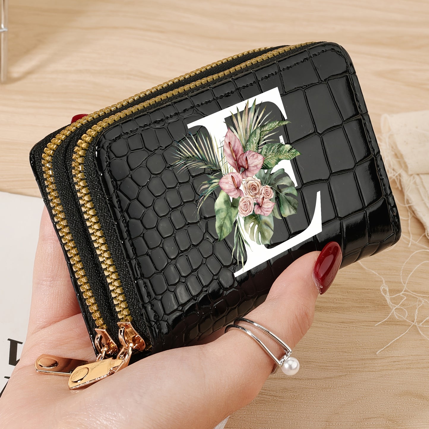 Women's credit card wallet with elegant floral letter print in black & white. Features large capacity, dual zipper, crocodile texture PU, lightweight design with nylon lining for everyday