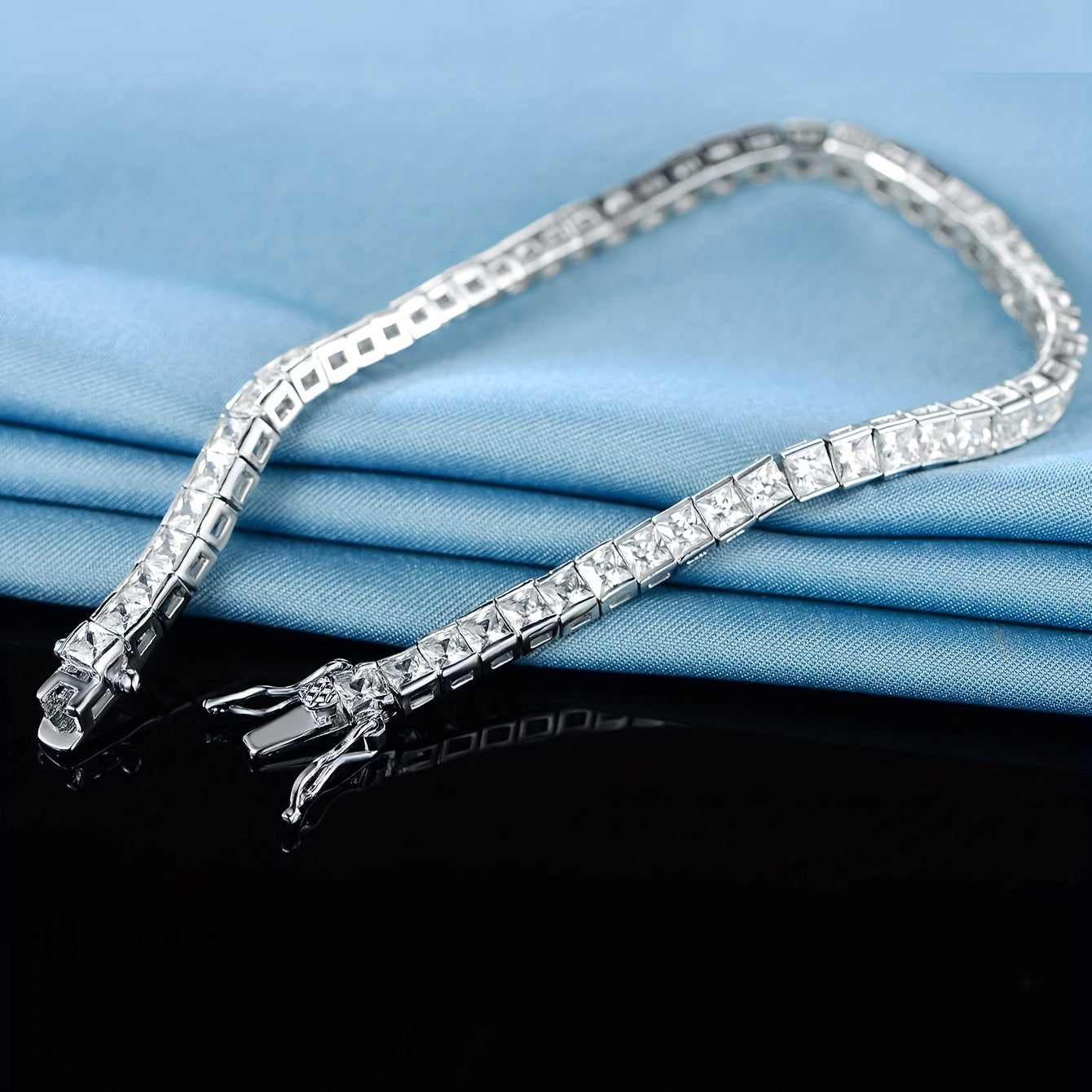 Elegant hand jewelry decor featuring a square, shiny zirconia tennis bracelet.