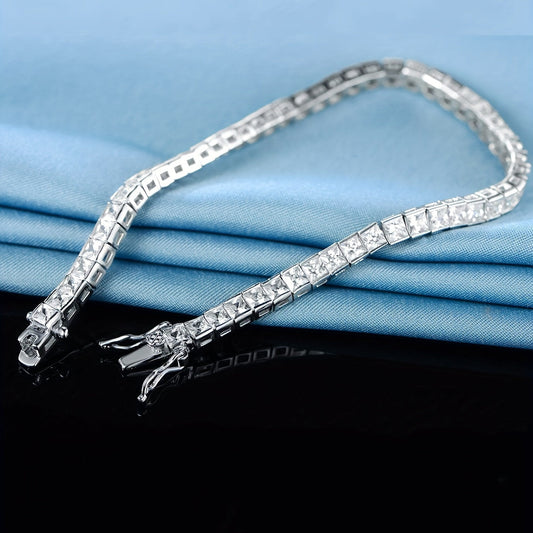 Elegant hand jewelry decor featuring a square, shiny zirconia tennis bracelet.