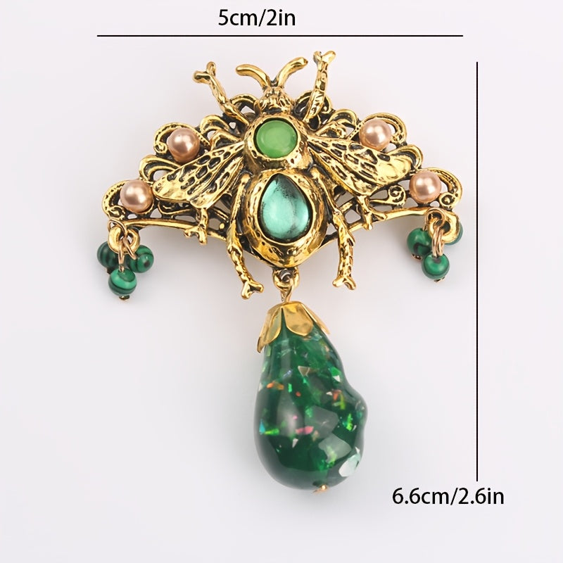 Bee brooch pin with vintage-inspired butterfly design, adorned with rhinestones and intricate green enamel accents, perfect for adding flair to coats and dresses.