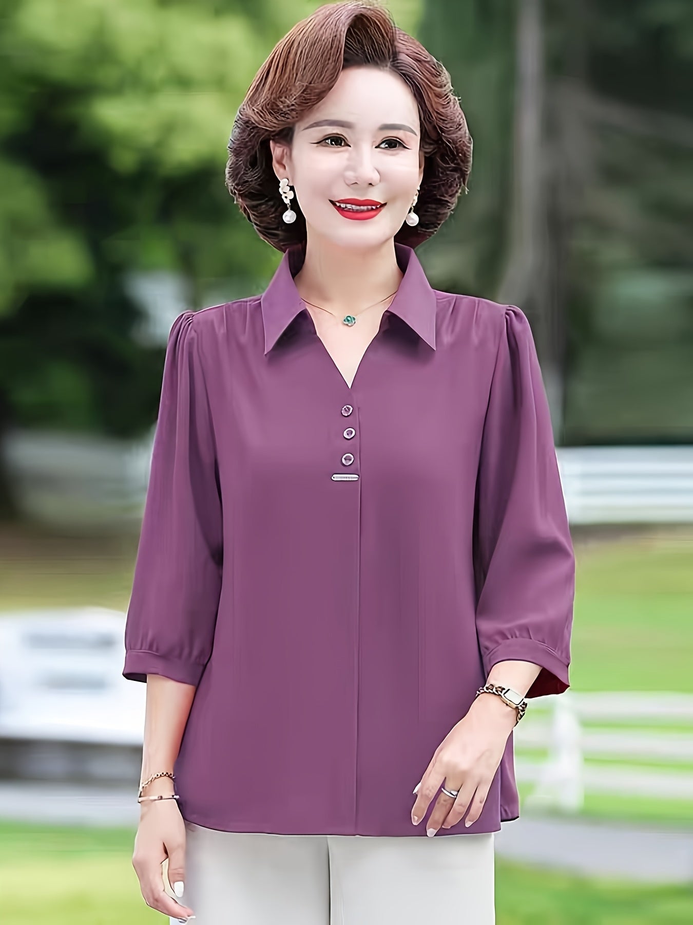 Stylish purple chiffon blouse for women with 3/4 sleeves, slimming fit, and decorative buttons. Made of lightweight polyester-elastane blend, perfect for spring, summer, and fall. Features