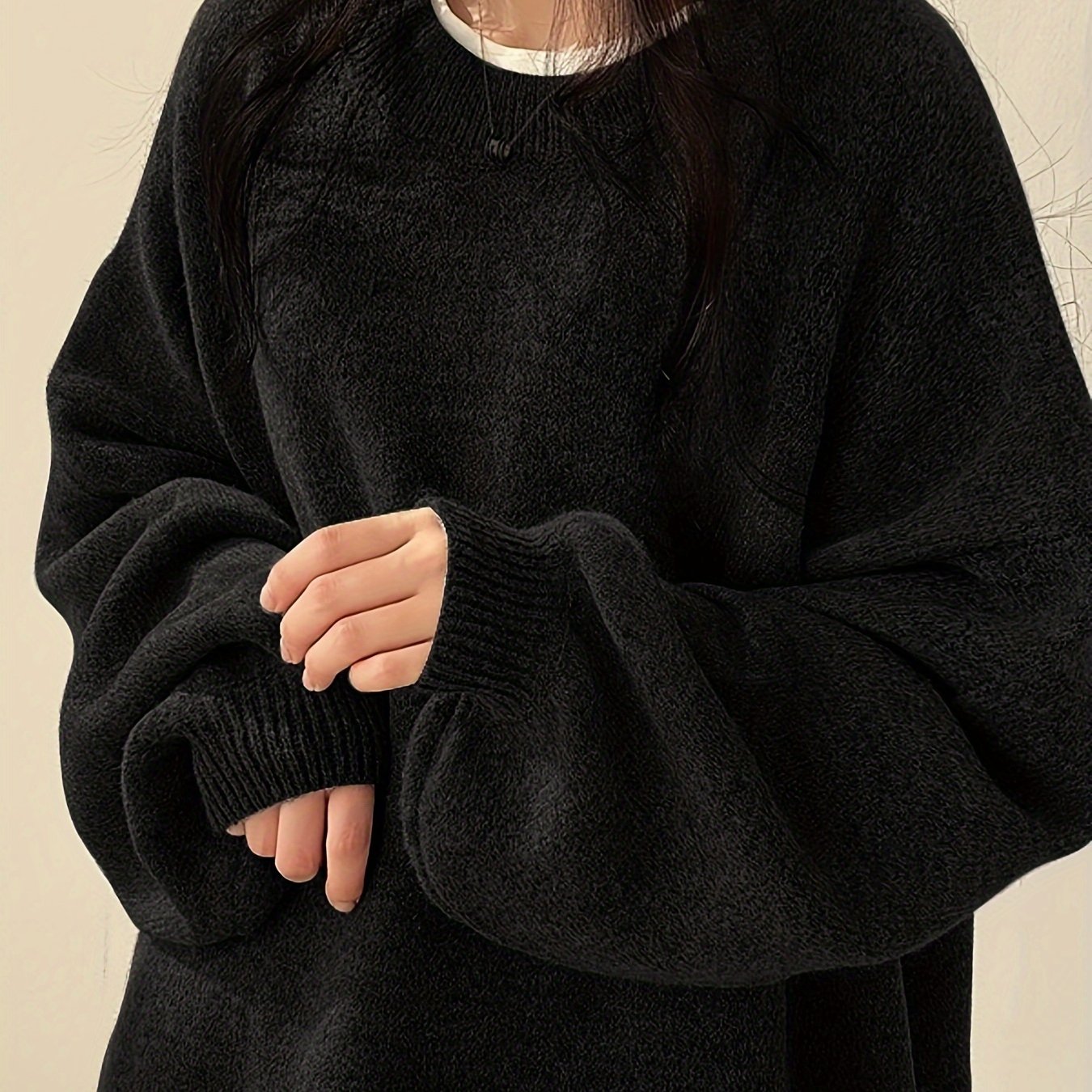 Women's solid crew neck sweater with drop shoulder and split hem for a casual look.