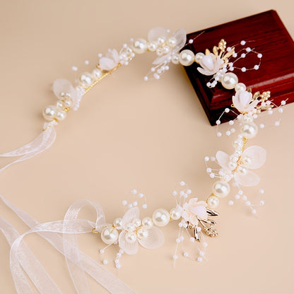 Elegant white plastic headband with floral design for girls, perfect for performances and vacations.