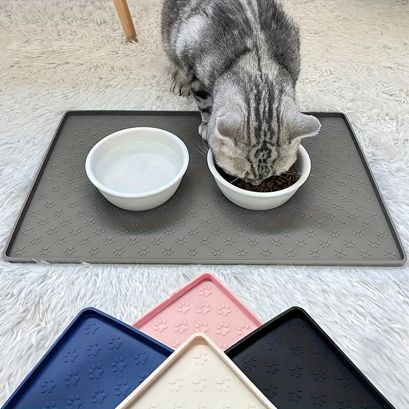 Gray pet feeding mat with paw print design, prevents spills and mess, ideal for cats and dogs.