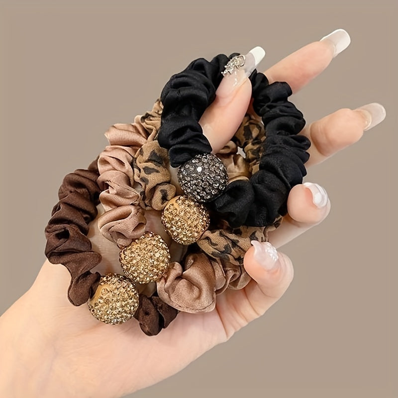 Set of 4 high elastic rhinestone hair ties with plain and leopard print designs.