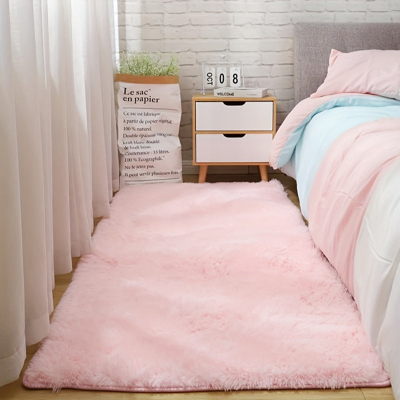 Soft and fluffy pink area rug, machine washable with a shaggy design. Perfect for adding a cozy touch to any living room, nursery, or dorm room. Non-slip and aesthetically pleasing.