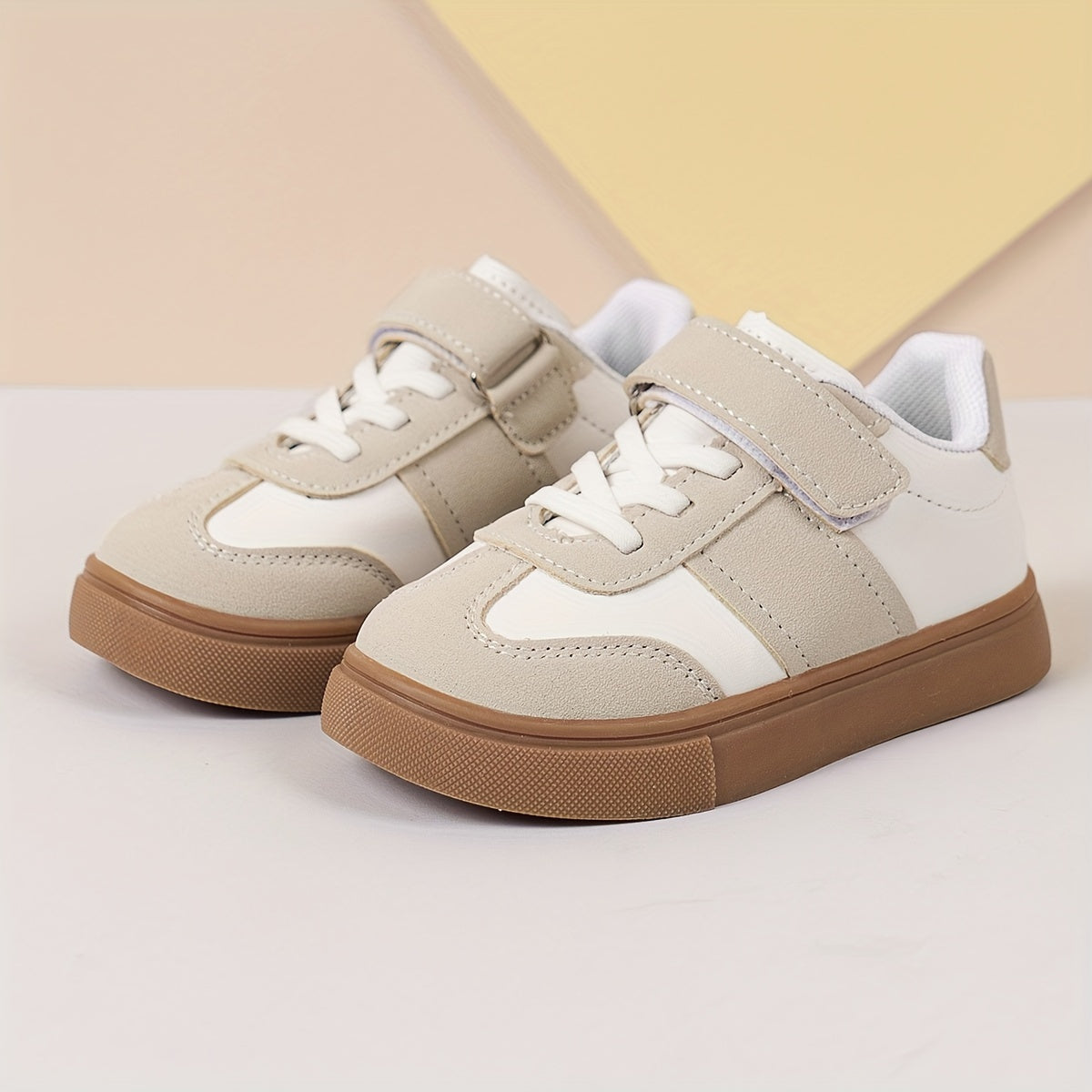 Youth sneakers with hook & loop fastener and non-slip sole, solid color design for boys and girls.