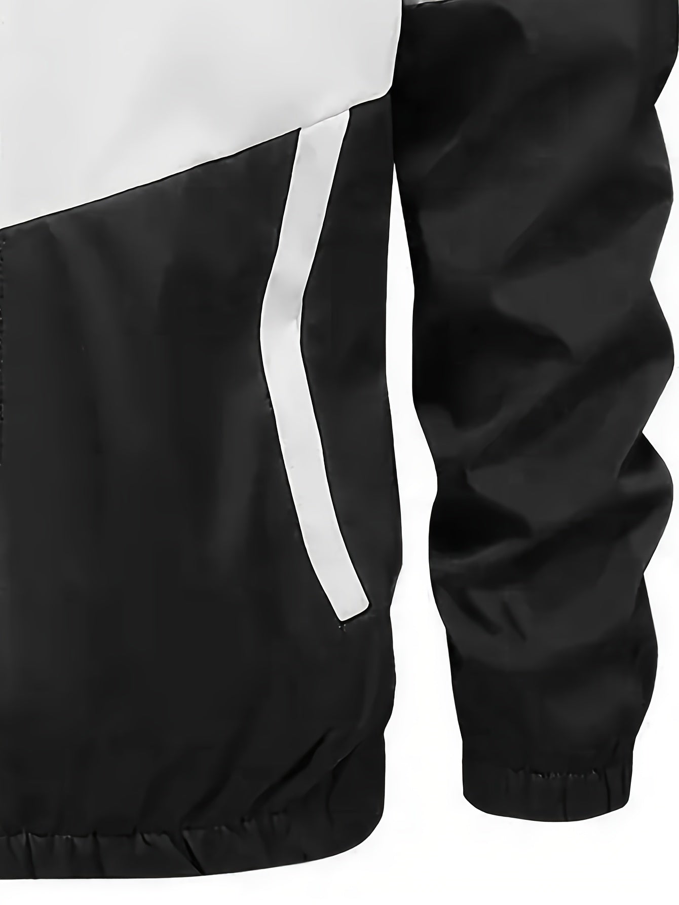 Casual men's sports suit with hooded jacket and pants, featuring a trendy color block design. Made of polyester with slight stretch, drawstring detail, and regular fit.