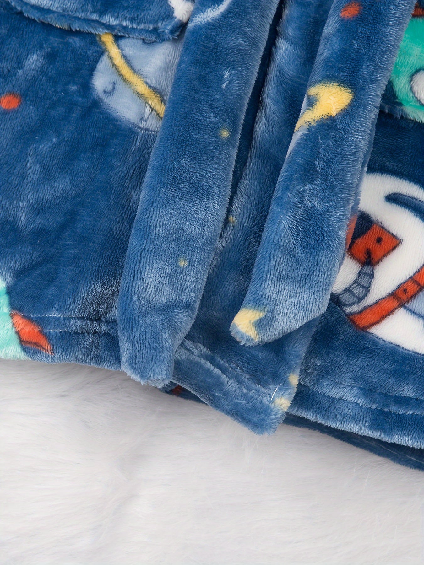 Soft and cozy space-themed boys' fleece robe with flame retardant technology. Features long sleeves, hood, pockets, and is machine washable. Ideal for home and party wear, perfect gift for