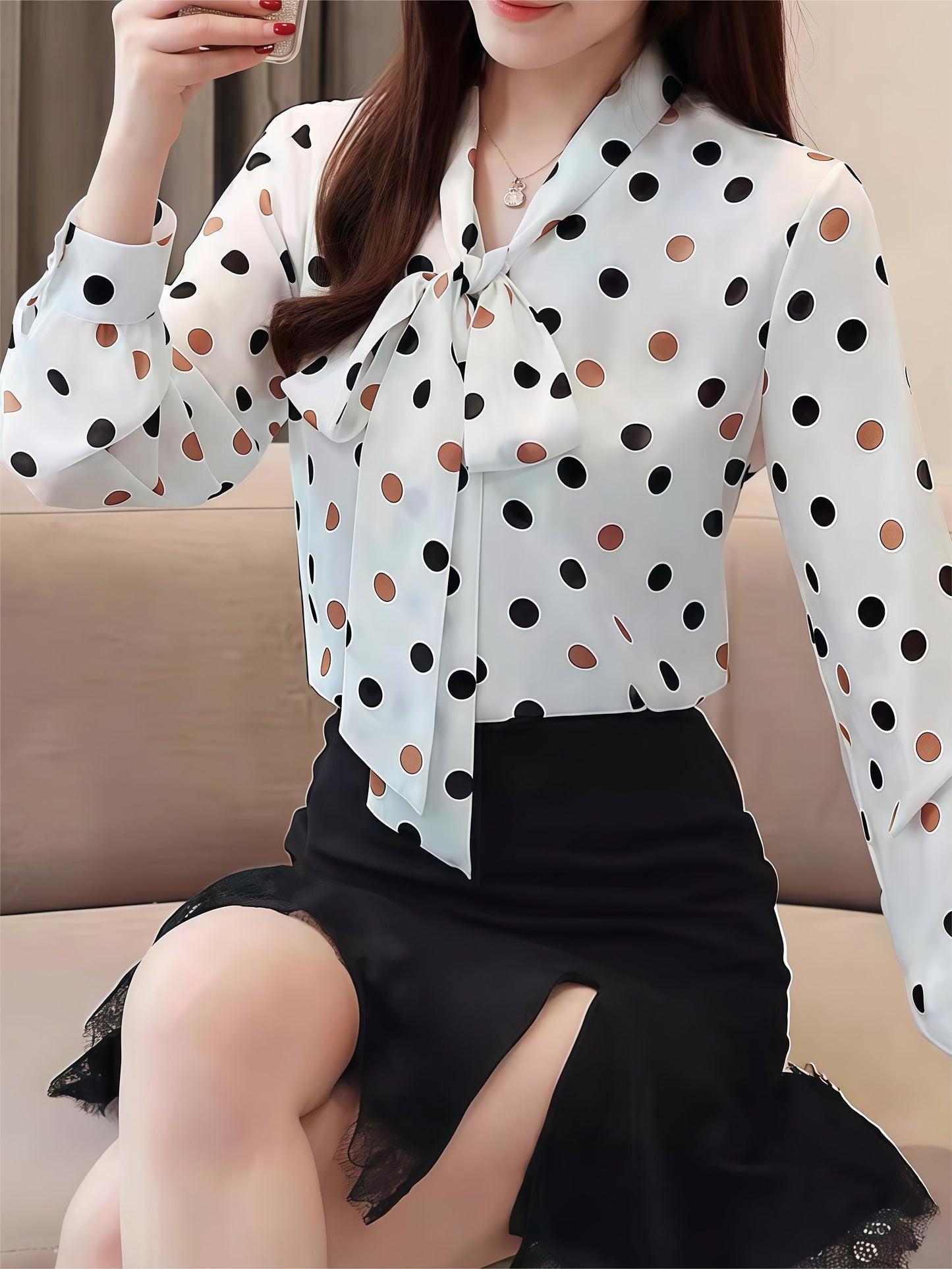 Elegant polka dot blouse with tie-neck detail, perfect for spring and fall.