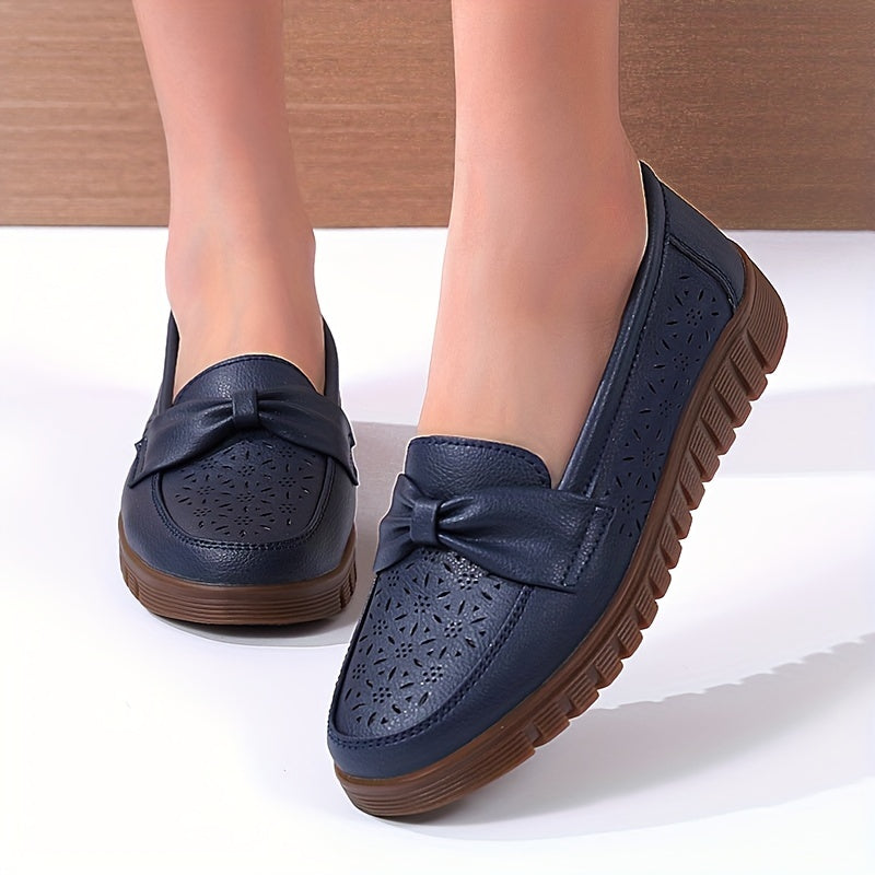 Women's breathable closed toe flat shoes with hollow out design.