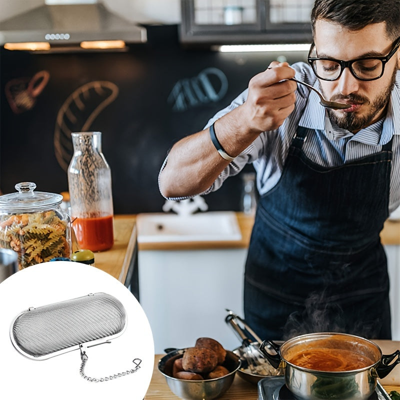 A tea infuser made of durable stainless steel featuring a 304 mesh strainer, perfect for brewing loose leaf tea, spices, and seasonings. This kitchen gadget comes with a convenient chain hook for easy removal from your cup or pot.