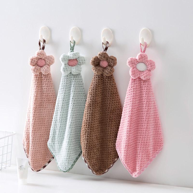 Decorative crochet flower hand towel made of absorbent microfiber with hanging loop. Perfect for kitchen or bathroom use in pink, mint green, white, or brown.