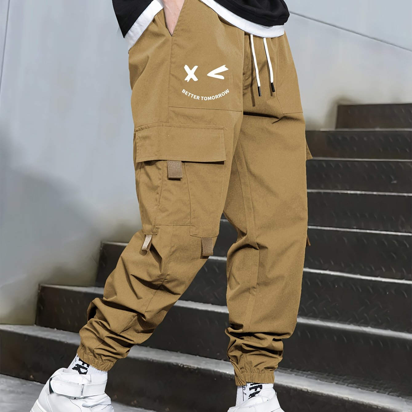 Stylish cargo pants with multiple pockets for men, featuring a loose fit and drawstring waistband for a casual outdoor streetwear look.