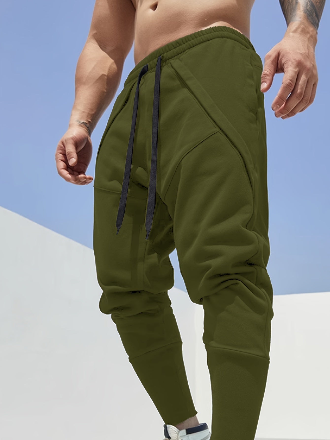 Casual style men's athletic sweatpants with tapered fit, side pockets, and adjustable drawstring for sports and relaxation.