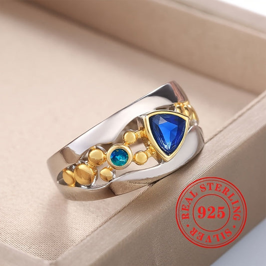 Vintage ring jewelry made of 925 sterling silver featuring a triangle cut blue synthetic gemstone in a two-color design.