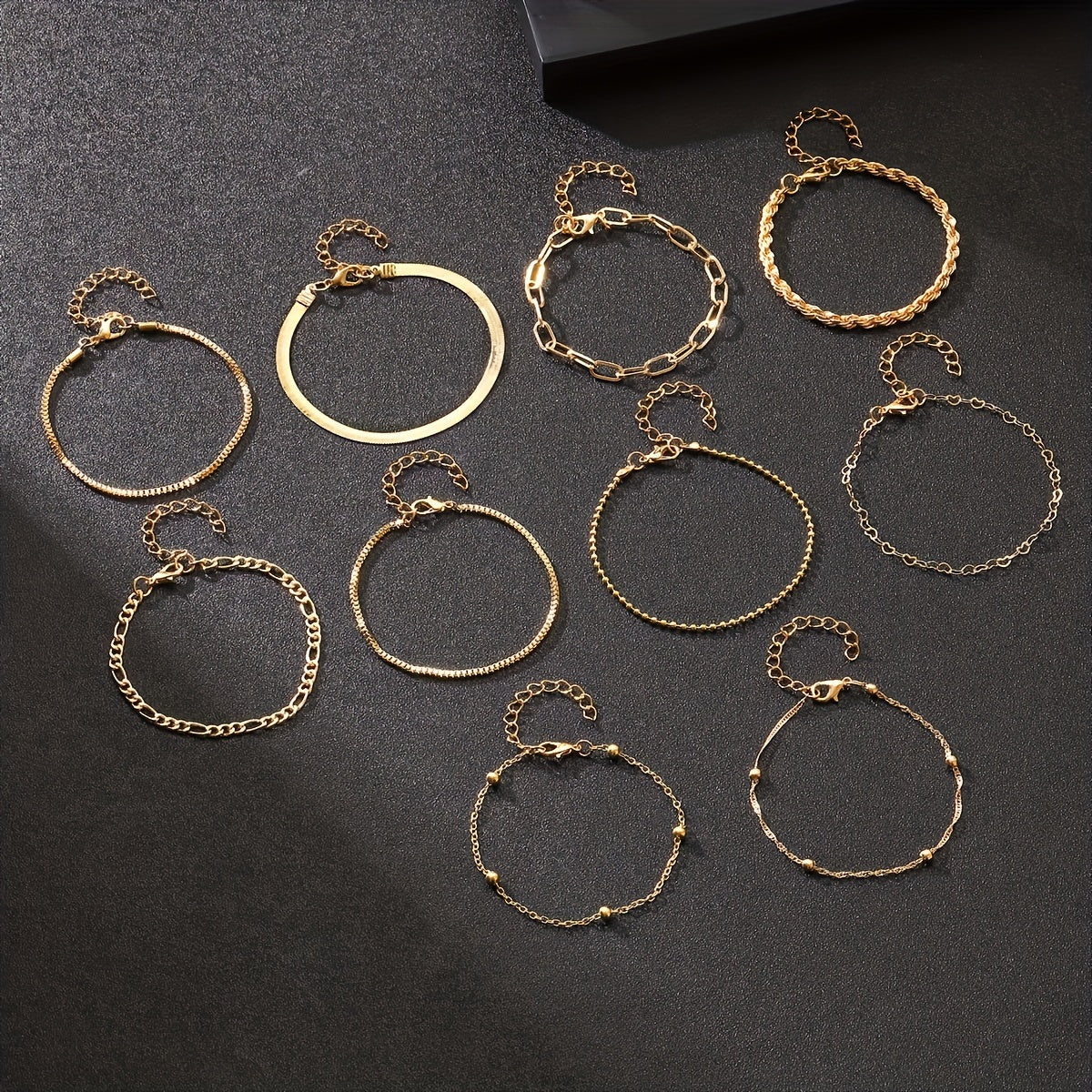 Set of 10 elegant golden-toned bracelets with multi-layer designs and heart charms, ideal for daily wear or parties.