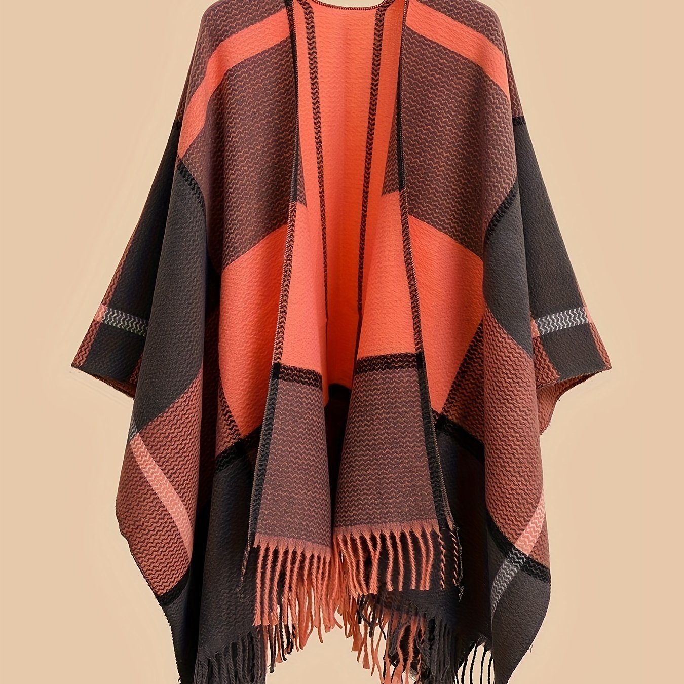 Stylish plus size shawl cardigan with tassels for fall/winter parties features v-neck, asymmetrical hem, and geometric pattern.