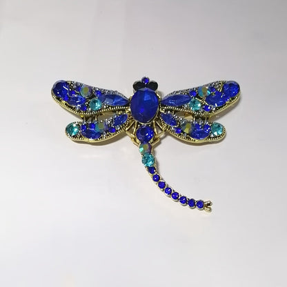 Dragonfly-shaped brooch with a retro design, adorned with sparkling rhinestones. Perfect for adding a touch of elegance to women's dresses, coats, sweaters, or corsages.