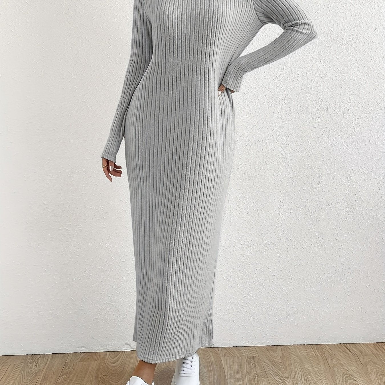 Elegant crew neck striped knit t-shirt dress made from a polyester and spandex blend. Features long sleeves and full-length ribbed knitwear for spring/fall.