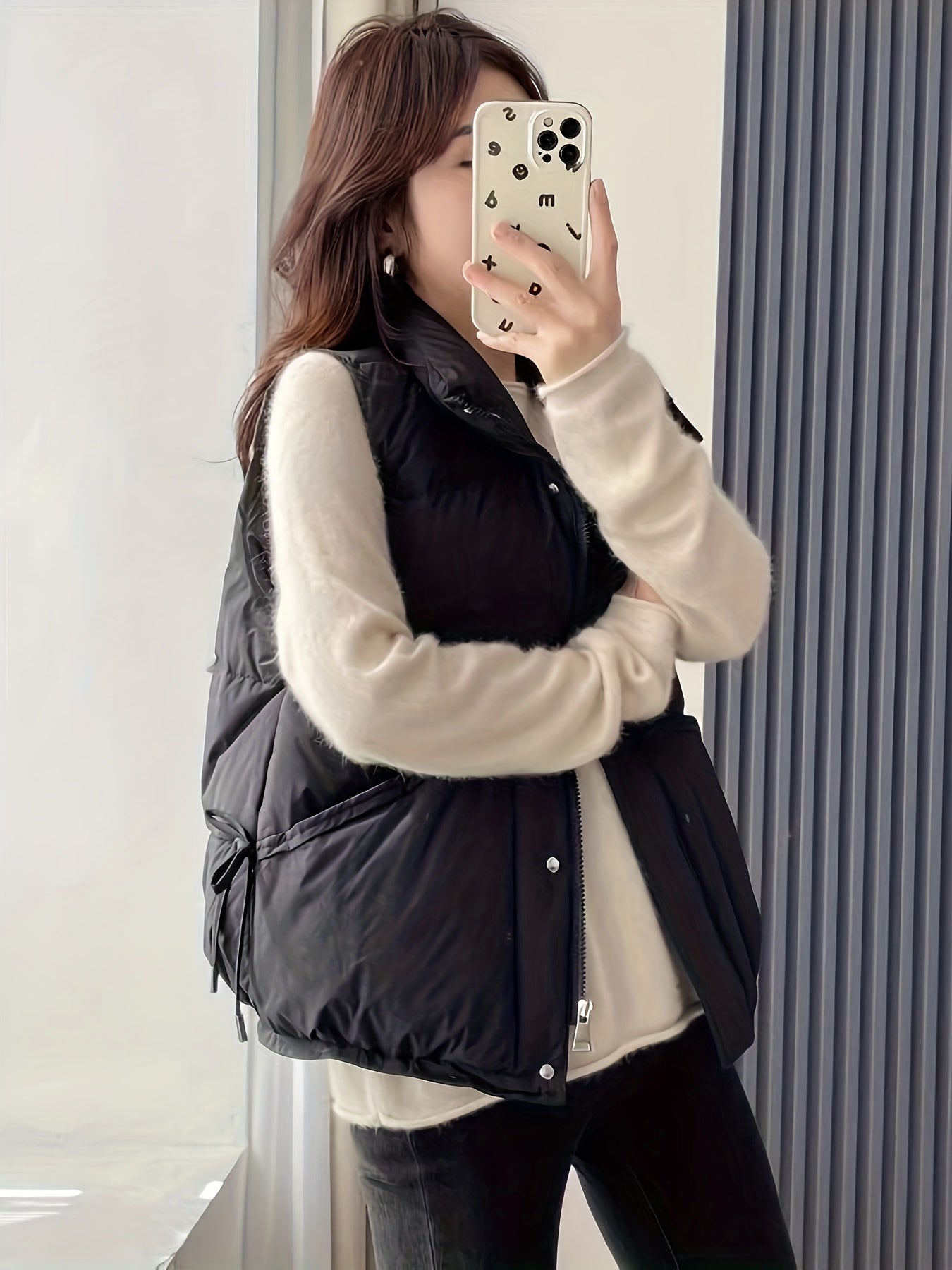 Waterproof sleeveless puffer vest in solid cream color with zippered pockets, perfect for casual daily wear.